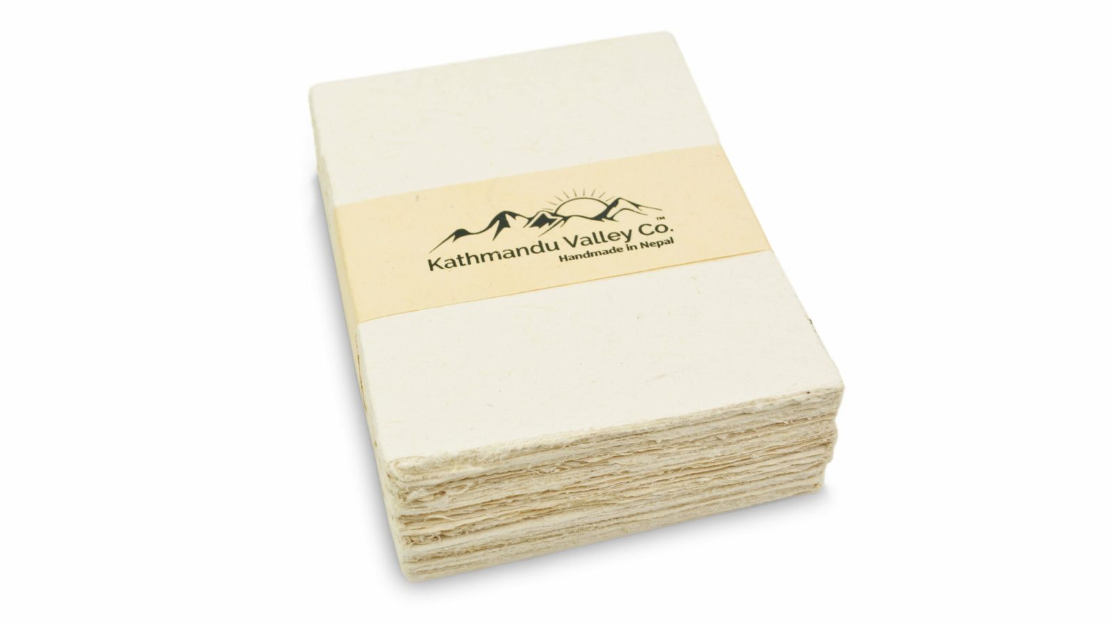 A stack of natural handmade lokta card stock with a deckled edge